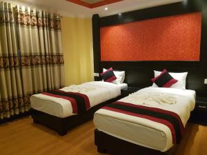 Voodi või voodid majutusasutuse Kathmandu Regency Hotel toas