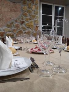 a table with wine glasses and plates on it at Balneario Casa Pallotti in Carranza