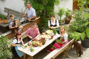 a group of people sitting around a picnic table at Bauer & Wirt Langthaler in Emmersdorf an der Donau