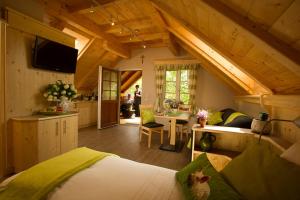a large room with a bed and a kitchen with at Bauer & Wirt Langthaler in Emmersdorf an der Donau