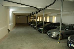 a row of parked cars in a parking garage at Adeba Hotel in Prague
