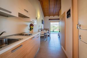 a kitchen with a sink and a dining room at Agriturismo Tre Colline in Bardolino