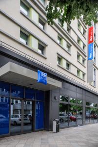 a large building with a sign on the side of it at ibis budget Berlin Kurfürstendamm in Berlin