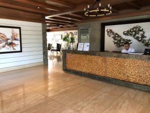 a lobby of a restaurant with a counter with a person at SMDC Wind Suites Jane's Condo in Tagaytay