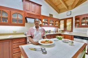 a man standing in a kitchen with a bowl of food at CASA NOSTRA RESORT by Klabhouse in La Romana