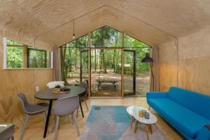 uma sala de estar com um sofá azul e uma mesa em Stayokay Hostel Apeldoorn em Apeldoorn