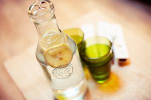 a bottle of lemonade and two glasses on a table at Ferienhaus zum Stubaier Gletscher - WALD in Neustift im Stubaital