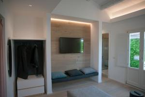 a room with a flat screen tv on a wall at 4 Elements Boutique Home in Siracusa