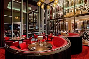 a bar with red chairs and tables in a restaurant at Tivoli Hotel in Copenhagen
