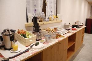 a buffet line with food and drinks on it at Agriturismo La Poina in Livigno