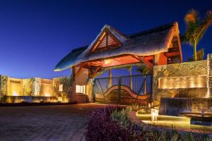 a home at night with the lights on at Clos du Littoral by Fine & Country in Grand-Baie