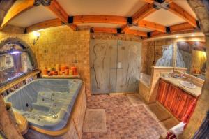 a large bathroom with a tub and a sink at Sunset Inn in Eilat