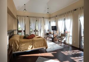 a bedroom with a bed and a desk in a room at Tufenkian Avan Dzoraget Hotel in Dzoraget +93 photos