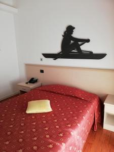 a bedroom with a bed with a red bedspread at Hotel Fioroni in Bellagio