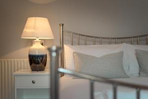 a bedroom with a bed with a lamp on a night stand at Anabelle's Guest House in Bath