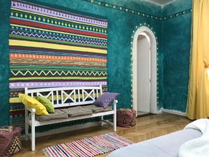 a childs room with a crib and colorful wallpaper at Timisoara Central Vibes Belle Vue Apartments in Timişoara +14 photos