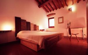 a bedroom with a large bed and a chair at B&B Eridu in Fiesole
