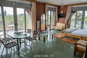 a bedroom with a bed and a table and chairs at Ionion Star Hotel in Preveza