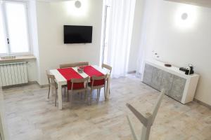 a dining room with a table and chairs and a tv at Santa Chiara 32 in Turin