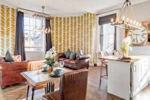a kitchen and living room with a table and chairs at The Thoresby at Claremont Serviced Apartments in Leeds +14 photos