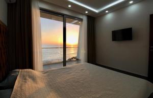 a bedroom with a bed and a view of the ocean at Apartments Komina in Utjeha +36 photos