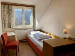 A bed or beds in a room at Hotel Schöne Aussicht