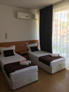 Postel nebo postele na pokoji v ubytování Dreams Family Hotel
