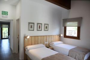 מיטה או מיטות בחדר ב-Hostal Ameztia