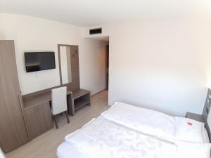 Postel nebo postele na pokoji v ubytování Hotel Garnì Villa Fontana