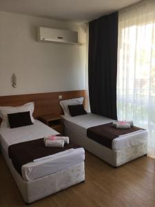 Postel nebo postele na pokoji v ubytování Dreams Family Hotel