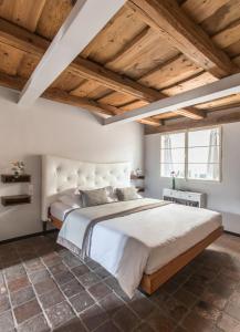 a bedroom with a large bed and wooden ceilings at Design Hotel Neruda in Prague