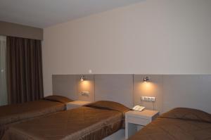 Ένα ή περισσότερα κρεβάτια σε δωμάτιο στο Achillio Hotel