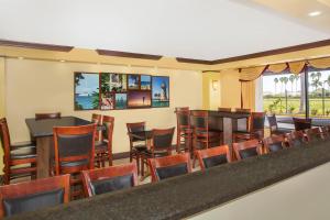 a dining room filled with tables and chairs at Days Inn by Wyndham Florida City in Florida City