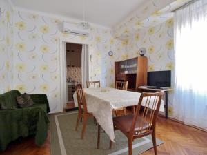 a dining room with a table and chairs at Guest house Ribaric in Rab