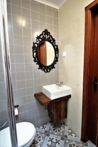 a bathroom with a sink and a mirror at Casa do Castelo in Elvas