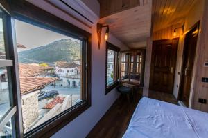a room with a bed and a large window at Heraklis Hotel in Berat