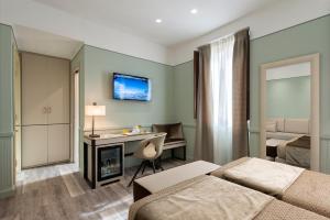 a room with a television and a bed at Atlante Star Hotel in Rome