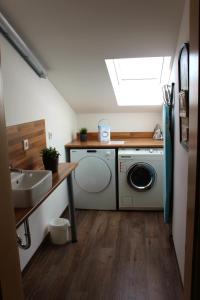 a bathroom with a washing machine and a sink at greenpartment Ingolstadt - Friedrichshofen in Ingolstadt