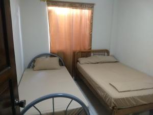 a room with two beds and a chair in it at Villa marina, santa elena in Santa Elena