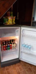 an open refrigerator with food and drinks in it at Siriwan Hostel in Chiang Mai