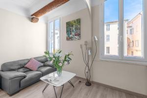 a living room with a couch and a table at My rima in Antibes
