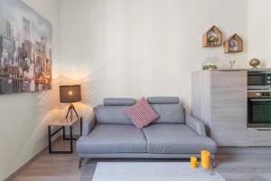 a living room with a couch and a table at My rima in Antibes