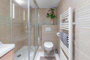 a bathroom with a shower and a toilet and a sink at My rima in Antibes