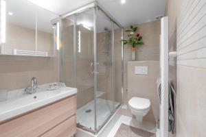 a bathroom with a shower and a toilet and a sink at My rima in Antibes