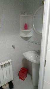 a white bathroom with a sink and a toilet at El Campello in El Campello