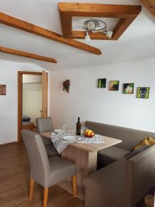 a dining room with a table and a couch at Hartl, Haus in Rauris