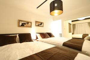 Säng eller sängar i ett rum på Prestige Suites Osaka Abiko