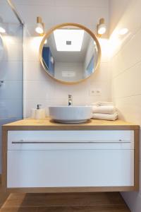 a bathroom with a sink and a mirror at Baltic Apartments Seaside Towers in Gdańsk