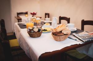 a table with baskets of food and bread on it at Hotel Le Flore in Fréjus