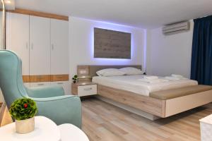 Postel nebo postele na pokoji v ubytování La Perla Apartments